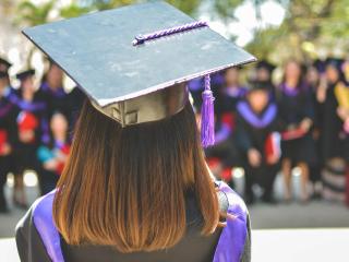 Female graduate from back looking into crowd. Photo by MD Duran on Unsplash
