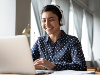 Woman on laptop with headphones