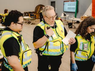 Emergency Response Unit personnel standing together, checking a list
