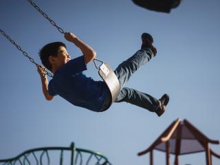Boy on Swing. Photo by Myles Tan on Unsplash