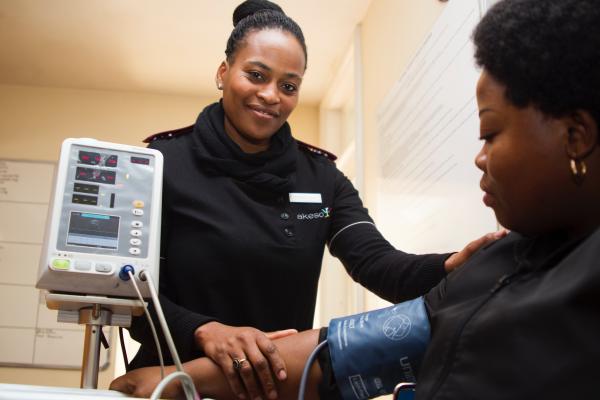Nurse taking blood pressure. Photo by Hush Naidoo on Unsplash