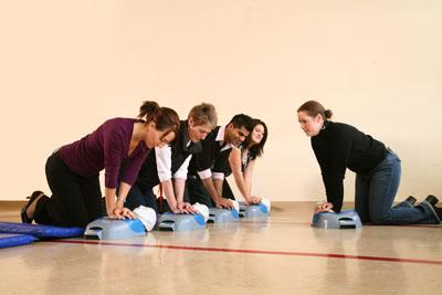 Group of people learning CPR in a gym