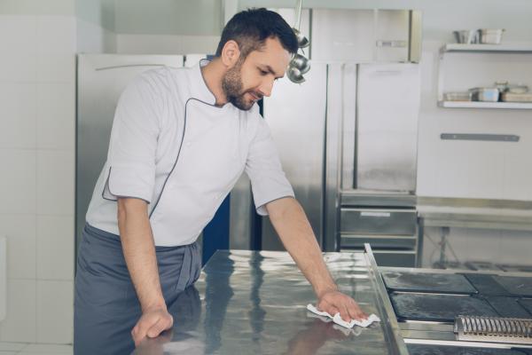 Chef cleaning restaurant kitchen