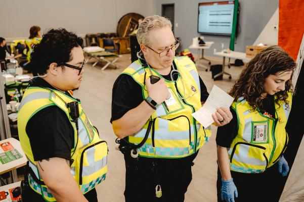Emergency Response Unit personnel standing together, checking a list
