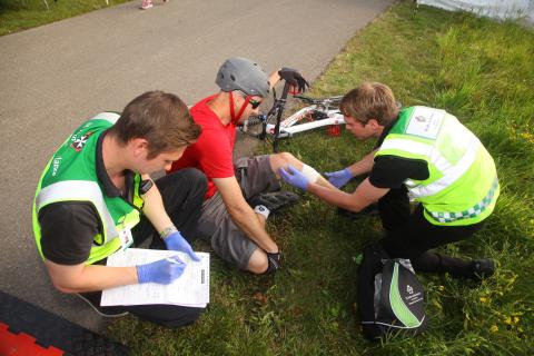 Patient being helped by SJA Medical First Responders after falling from his bike.