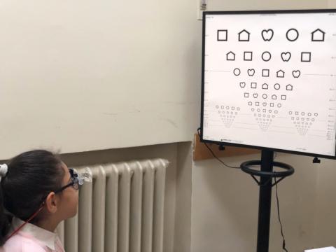 Little Girl looking at eye chart